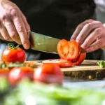 depositphotos_215133256-stock-photo-chef-cook-preparing-vegetables-his