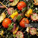 Grilled veggie skewers with cherry tomatoes, radishes, peppers and onions with fresh dill on a grill pan