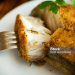 catfish roasted in batter on a wooden table