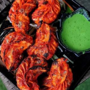 Spicy Achari Momos tossed in tangy achari masala in Delhi NCR